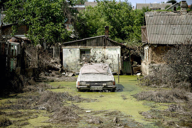 abandoned car in Kherson in an area flooded by rising water