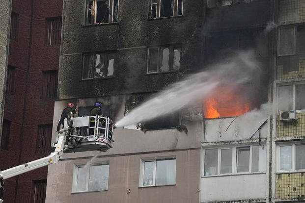 Firefighters work to extinguish a fire in an apartment building after Russian attack in Kyiv, Ukraine
