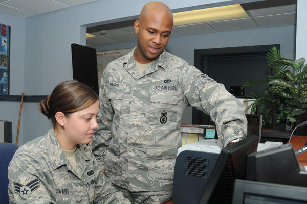 Airmen at a computer, teaching and education.