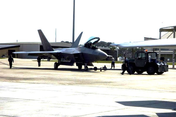 An F-22 Raptor is towed to its hangar on Feb. 27 at Tyndall Air Force Base, Fla. (Military.com photo/Oriana Pawlyk)
