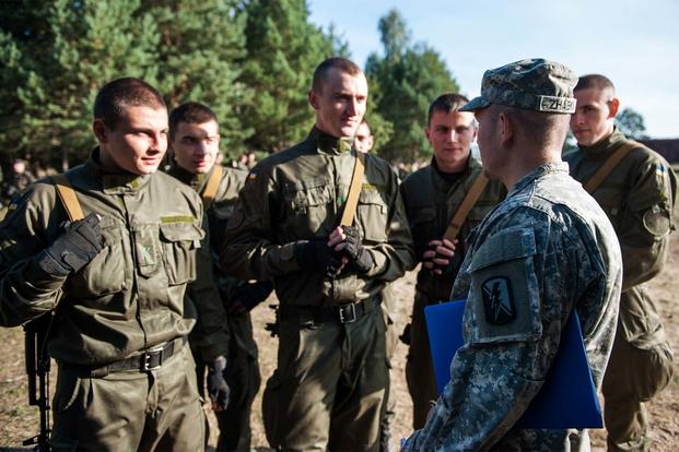 U.S. Army Spc. Zhabka Aleksey, a California National Guard Soldier from the 223rd Military Intelligence Battalion talks to Ukrainian National Guard Soldiers during Exercise Rapid Trident in 2014 in Yavoriv, Ukraine. (Army Photo: Spc. Joshua Leonard)