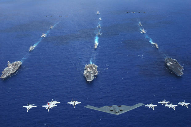 An Air Force B-2 bomber along with other aircraft from the Air Force, Navy and Marine Corps fly over the Kitty Hawk, Ronald Reagan and Abraham Lincoln Carrier Strike groups during Exercise Valiant Shield 2006. (US Navy)