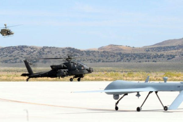 An AH-64D Apache Longbow and MQ-1C Gray Eagle helicopter land at Michael Army Airfield, Utah, Sept. 16, 2011, after the completion of the Manned Unmanned Systems Integration.  (U.S. Army photo)