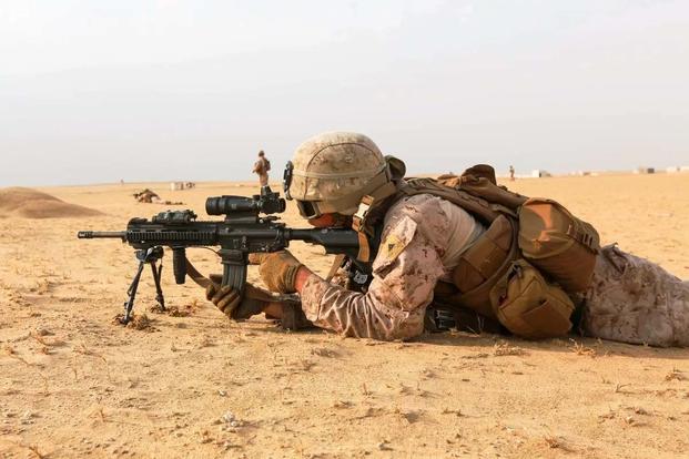 A U.S. Marine fires his M27 Infantry Automatic Rifle while conducting squad attack exercise in Bahrain on Dec. 1, 2016. (Marine Corps photo/Manuel Benavides)
