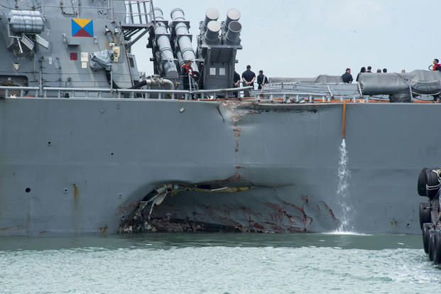 Damage to the portside is visible as the Guided-missile destroyer USS John S. McCain steers towards Changi Naval Base, Republic of Singapore, following a collision with the merchant vessel Alnic MC on Aug. 21, 2017. (U.S. Navy photo/Joshua Fulton)