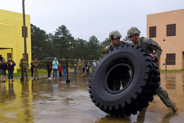 Army Staff Sgt. Erich Friedlein, left, and Army Capt. Robert Killian, move a large truck tire while competing in the 2016 Lt. Gen. David E. Grange Jr. Best Ranger Competition at Fort Benning. (Army National Guard/Staff Sgt. D. Richard Salzer) 