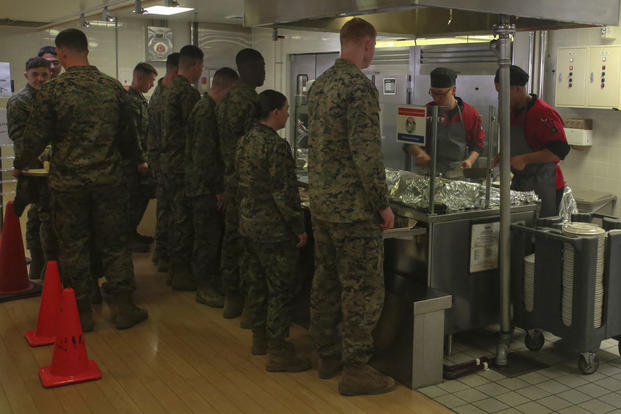U.S. Marines wait in line while food service specialists sauté Mongolian entrée selections on the grill in the R.G. Robinson Mess Hall at Marine Corps Air Station Iwakuni, Japan, Feb. 8, 2017. (U.S. Marine Corps photo/Lance Cpl. Carlos Jimenez)
