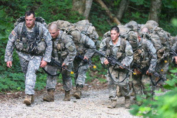 Ranger candidates, burdened with heavy packs and weapons, hike up a trail during the Mountain Phase of the traditionally all-male infantry course. (Army Photo)