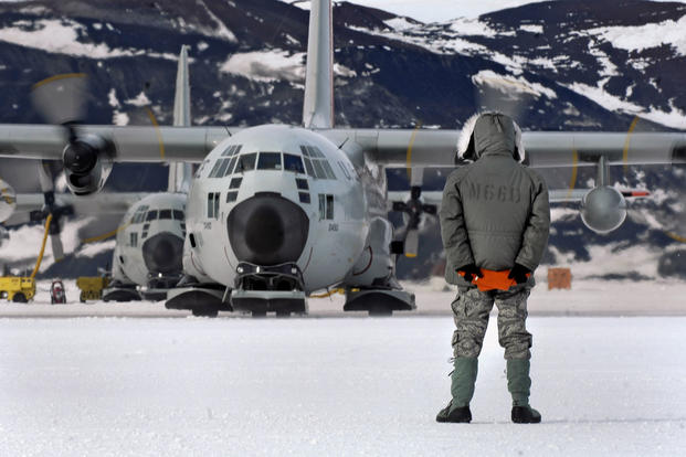 An LC-130 Hercules is marshaled from its parking spot on the annual sea ice runway near McMurdo Station, Antarctica, during Operation Deep Freeze. Tech. Sgt. Shane A. Cuomo/Air Force