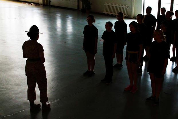 A drill instructor from Marine Corps Recruit Depot Parris Island, S.C., teaches Marine Corps Drill to female poolees, women currently enrolled in the Marine Corps’ Delayed Entry Program. (Sgt. Richard Blumenstein/Marine Corps)