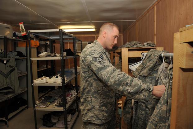 Staff Sgt. Robert Kitchen sorts Airman Battle Uniforms at the 379th Air Expeditionary Wing in Southwest Asia, on Oct. 16, 2013. The Air Force is considering shifting from the ABU to the Army Combat Uniform. Master Sgt. David Miller/Air Force