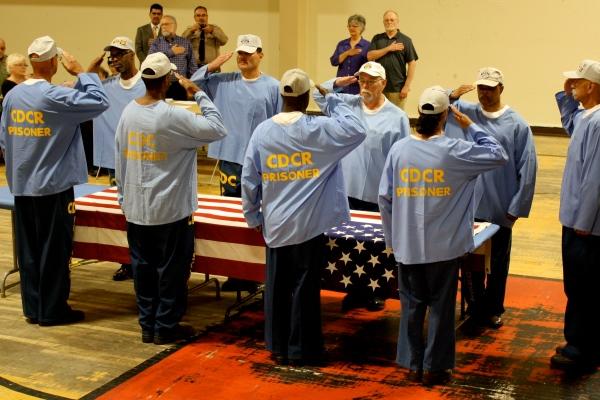 Incarcerated veterans at California's Correctional Training Facility salute before folding the US flag. (California Dept.   of Corrections and Rehabilitation)