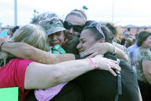 National Guard family members give a group hug after a deployment. U.S. Army photo