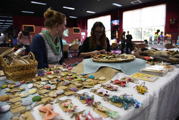 An Air Force spouse displays crafts at a home business expo. (Photo: U.S. Air Force/ Senior Airman Michael)