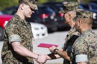 Maj. Gen. Carl E. Mundy III awards the Bronze Star medal with Combat “V” to Staff Sgt. Patrick H. Maloney, multi-purpose canine handler with 2nd Marine Raider Battalion, at Camp Lejeune, N.C., on Oct. 30, 2017. Sgt. Salvador R. Moreno/Marine Corps