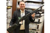 John Fink of Remington shows off the company's detachable mag shotgun. Photo by Hope Hodge Seck/Military.com