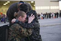 A Marine embraces her son and husband aboard Marine Corps Air Station Beaufort Jan. 12. (U.S Marine Corps/Lance Cpl. Kayla Rainbolt)