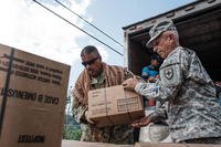 Members of the National Guard load pick-ups with food and boxes of water. (National Guard/Eduardo Martinez)