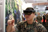 Marine Lance Corp. Nicholas Reedy, an artillery maintainer, demonstrates the Enhanced Maintenance Operations technology at Modern Day Marine 2018. The goggles equipped with augmented reality allow Marines to work on a 3-D model of an M777 155mm howitzer. (Military.com/Matthew Cox)