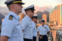 Coast Guard Cutter Sherman crewmembers line the rail of the flight deck prior to evening colors during a ceremony aboard the Sherman in Honolulu, Mar. 28, 2018. (U.S. Coast Guard photo/Matthew Masaschi)