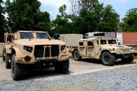 A Marine Corps Humvee and Joint Light Tactical Vehicle sit next to each other aboard Quantico, Va. (Matthew Cox/Staff)