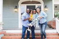 Family with &quot;sold&quot; house sign