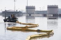 Contracted deploy a spill containment boom around the Offutt Air Force Base fuel storage area as a precautionary measure March 18, 2019 following flooding of the southeast portion of the base. (U.S. Air Force/Delanie Stafford)