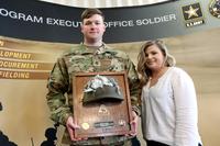 Staff Sgt. Steven McQueen, and his wife Aaron, with a plaque featuring a portion of the Enhanced Combat Helmet that saved his life during an insider attack in Afghanistan last year. (Military.com/Matthew Cox)