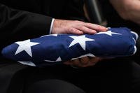 A folded flag at a memorial service.