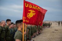 Marines hold the Marine Corps flag.