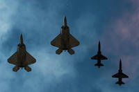F-22 Raptors and T-38 Talons perform a fly over