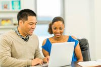 two students looking at laptop