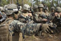 A Marine sergeant passes final instructions before assaulting an objective during the Infantry Integrated Field Training Exercise at Camp Geiger, N.C.