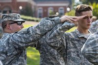 ROTC cadet is shown how to salute properly