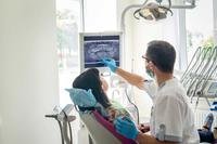 Dentist with patient in chair