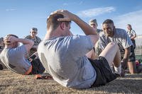 ROTC cadet performs sit-up during Army Physical Fitness Test.