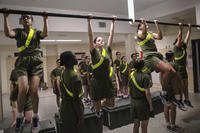 Marine recruits do pull-ups during their initial strength test.