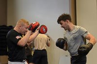 Senior airman blocks punches during combative training.