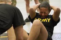 A soldier does sit-ups during the Army physical fitness test.