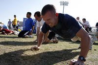 Athletes battle through two minutes of push-ups during the Navy SEAL Fitness Challenge.