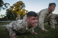 A Marine sniper candidate does a max set of push-ups.