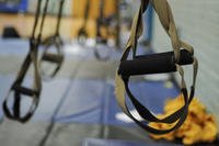Suspension straps hang from a bar during a TRX Circuit Blast class at Naval Station Norfolk, Virginia.
