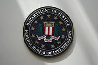 FBI seal is seen on a wall