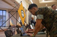 A U.S. Marine creates a profile with the Indiana Veterans Program to help him find job opportunities in Indiana at a career and exploration fair on Marine Corps Base Camp Lejeune, North Carolina.