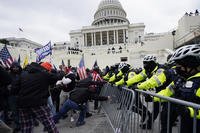 Rioters supporting President Donald Trump try to break through a police barrier at the Capitol