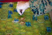 A U.S. Marine moves game pieces during a game of Memoir 44