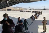 Afghan and American evacuees board a C-17 at Kabul International Airport