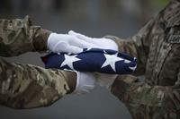 U.S. soldiers transfer colors during a disinterment ceremony