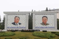 North Koreans visit the portraits of late leaders Kim Il Sung and Kim Jong Il
