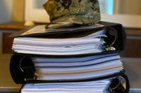 A picture of the binders collected by Navy Lt. Christa Gunsauley containing documents from the sexual harassment complaints she’s filed.